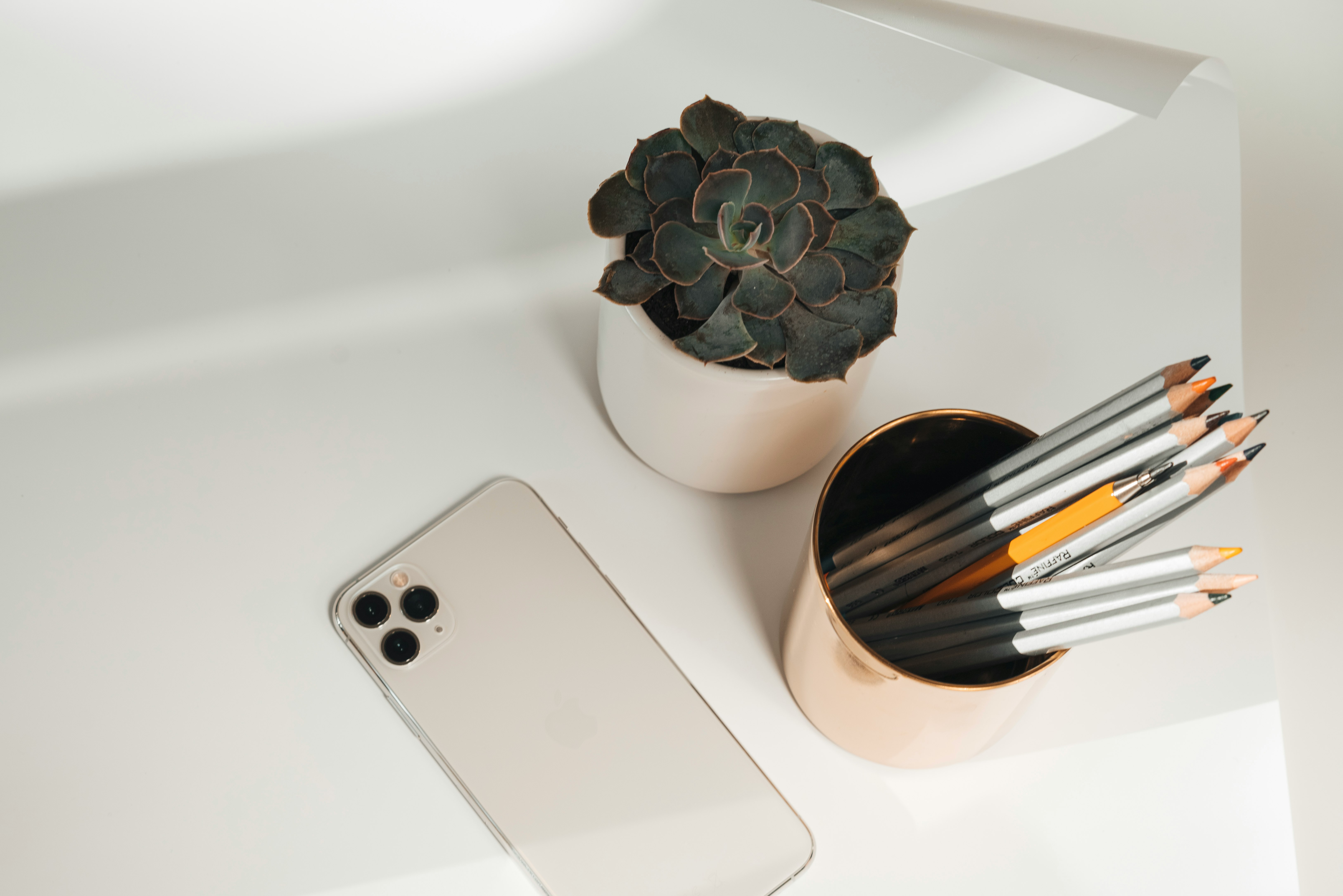 space gray iphone 6 beside white ceramic vase